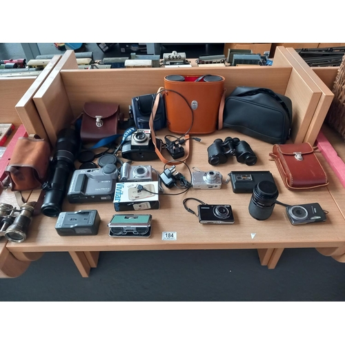 184 - A collection of vintage cameras, binoculars, Sony and Cannon cameras and lenses