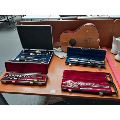 201 - Four cased vintage flutes and an acoustic guitar