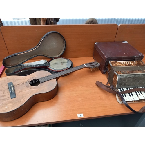 212 - An acoustic guitar, accordian with case and banjo with case