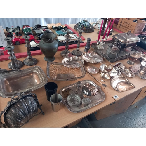 217 - A good selection of silver plated items to include candlesticks, butlers trays, shell dishes etc