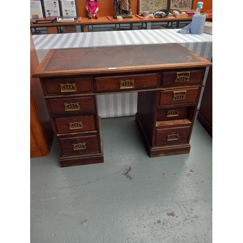 303 - An oak   twin pedestal desk with leathrette insert