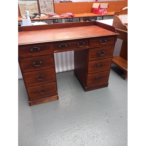 304 - An inlaid mahogany twin pedestal desk with gallery