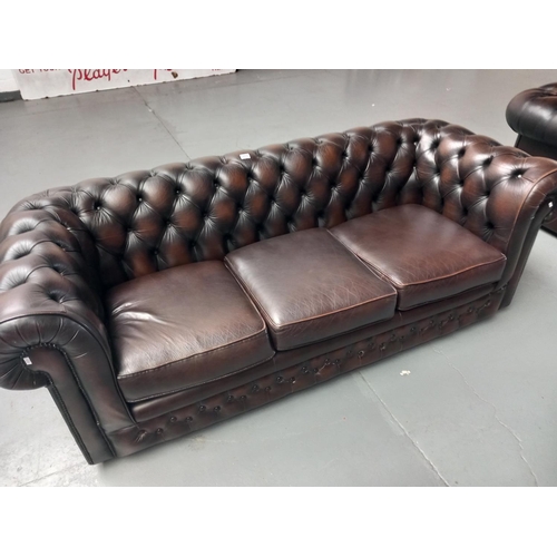 313 - A brown leather chesterfield three seater sofa