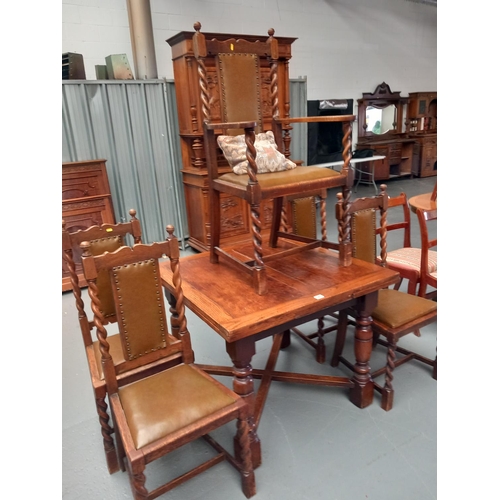 320 - An oak draw leaf extending dining table with five chairs to include one carver