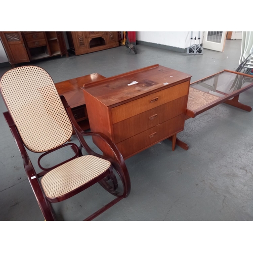 323 - A teak chest of drawers, tiled and glass topped coffee table together with a cane rush seated americ... 