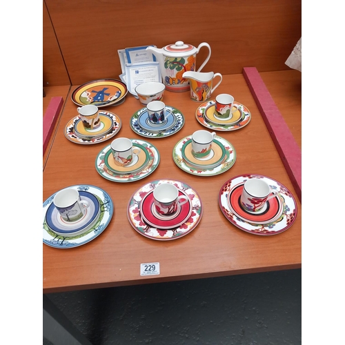 229 - A Wedgwood (Clarice Cliff) coffee set consisting of coffee pot, milk and sugar bowl and 8 trios