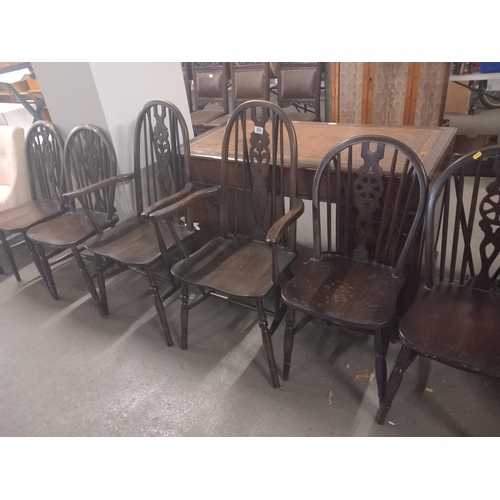 564 - Four wheelback dining chairs together with two fleur de lys back carvers