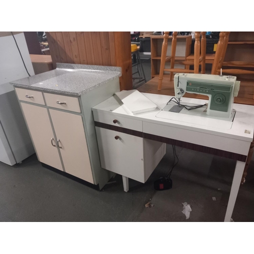 566 - A formica top kitchen cabinet and a retro sewing machine with cabinet