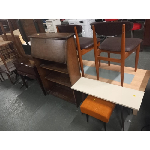 569 - An oak bureau, three dining chairs, two coffee tables etc