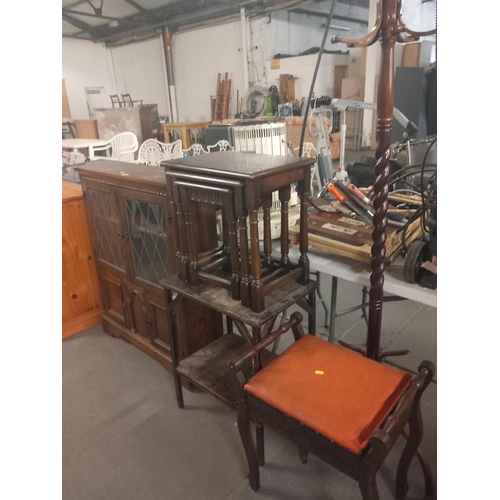 587 - An oak bookcase, nest of tables, hall stand and piano stool