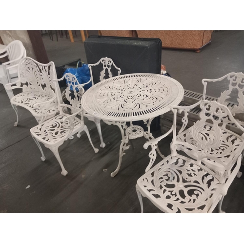 616 - A cast iron circular garden table, four chairs and a two seater garden bench