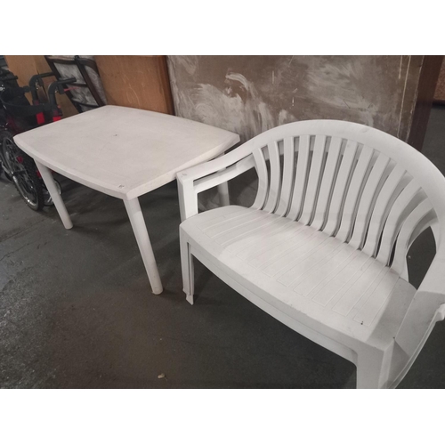 617 - A plastic garden table and two plastic two seater garden benches