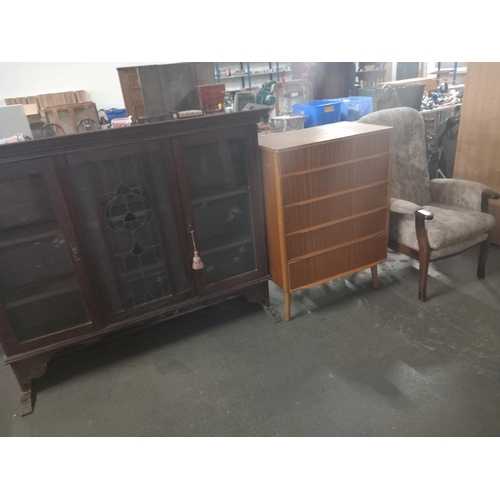 622 - An Austin suite chest of drawers, fireside armchair an oak display cabinet