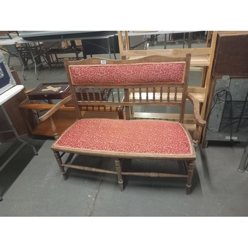 628 - A wooden upholstered two seater chair (needs attention)