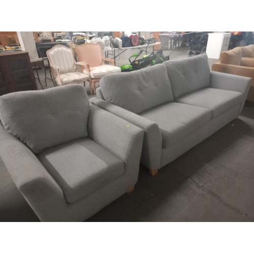 636 - A grey fabric three seater sofa with matching armchair