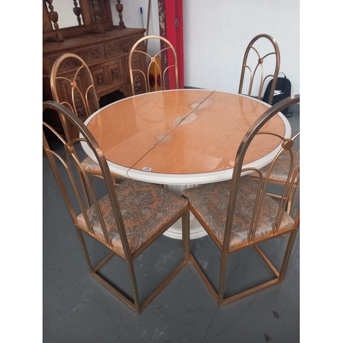 336 - A circular extending birdseye maple single pedestal dining table with six brass framed dining chairs... 