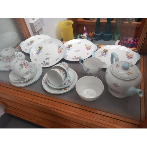 404 - A Shelley Wild Flowers part tea service - four trios, a teapot, sugar bowl, milk jug (tiny chip), fo... 