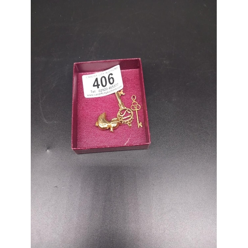 406 - Three 9k gold charms - a duck, an 18th birthday key, and a 21st birthday key (weight 4.98 grams)