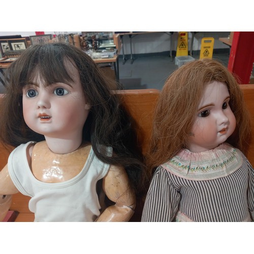 235 - Two antique dolls with bisque heads and composite bodys one being 30 inches tall and the other being... 