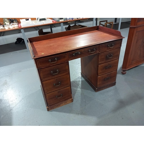 107 - An inlaid mahogany twin pedestal desk with gallery