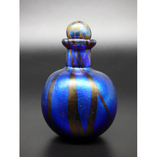 74 - Norman Stuart Clarke, an iridescent vase and perfume bottle, together with an iridescent paperweight... 