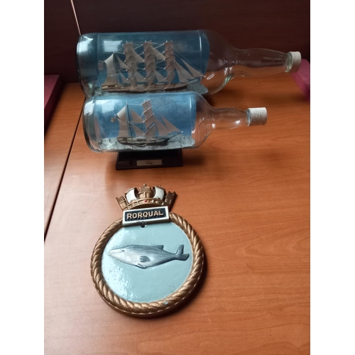 62 - Two model ships in glass bottles and an aluminium plaque believed to be from a ship