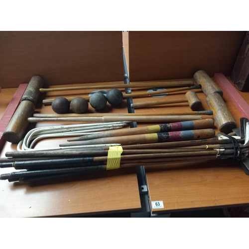 63 - A collection of antique and vintage golf clubs and an early croquet set