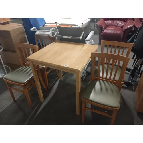 454 - A dining room table and four chairs