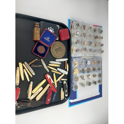 220 - A collection of pin badges, medallions, coins etc together with a collection of vintage pen knives