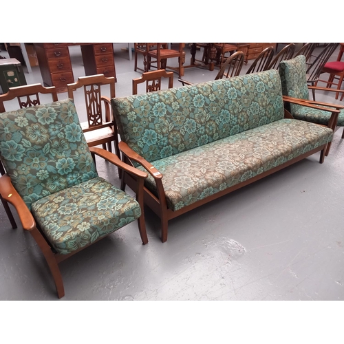 134 - A mid century style upholstered sofa bed together with two matching armchairs