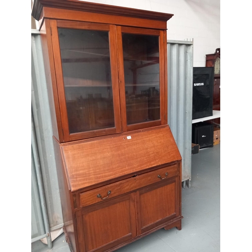 137 - An oak bureau bookcase