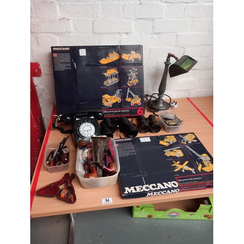 94 - Two Meccano sets (boxed), a bankers lamp, binoculars, vintage telephone, smoking pipes, car badges, ... 