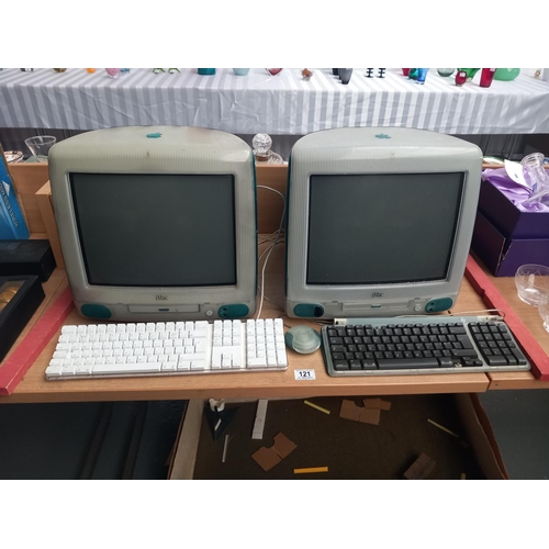 121 - Two Apple iMac computer screens with keyboards