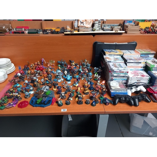 164 - A collection of Skylanders figures together with an assortment of PlayStation and Xbox games