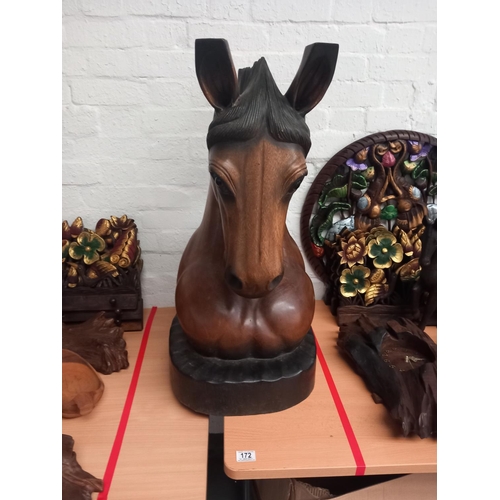 172 - A wooden carved horse's head on stand