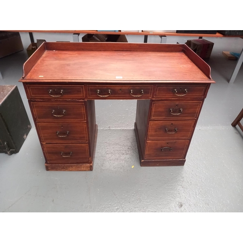 205 - An inlaid mahogany twin pedestal desk with gallery