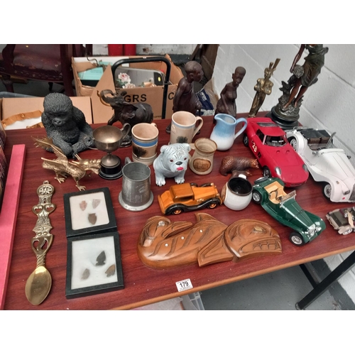 179 - A Spelter figurine, african carvings, decorative brassware and model cars