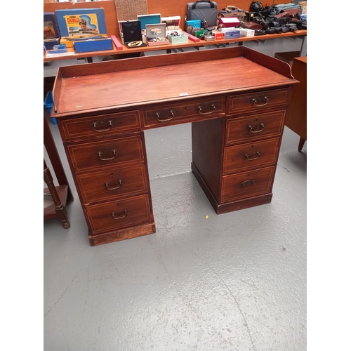 205 - An inlaid mahogany twin pedestal desk with gallery