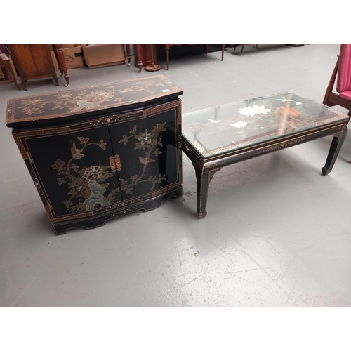 217 - A reproduction Chinese two door cabinet and glass coffee table