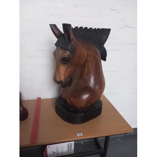 14 - A wooden carved horse's head on stand