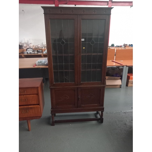 102 - An oak bookcase/display cabinet with glazed doors