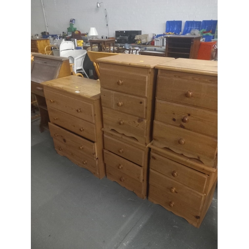 373 - A pine chest of drawers, pine bedside cabinets and an oak bureau