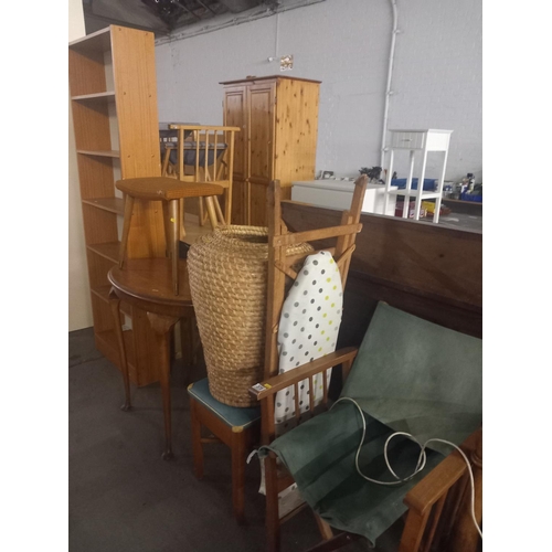 375 - A pine bookcase, wicker basket, occasional table, folding chair standard lamp etc