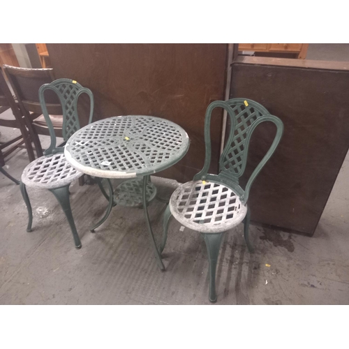 392 - A cast iron garden table and two chairs