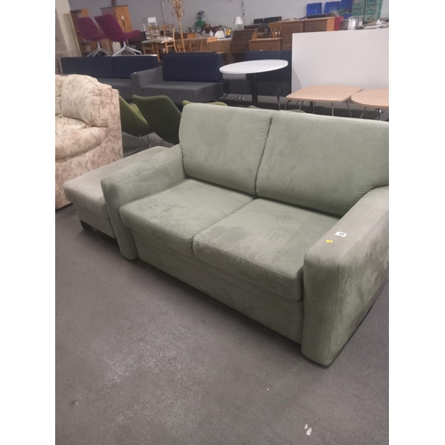 421 - An upholsterd fabric sofa bed together with a footstool