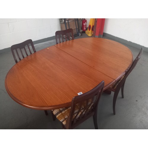 144 - An oval teak G Plan extending dining table and four chairs