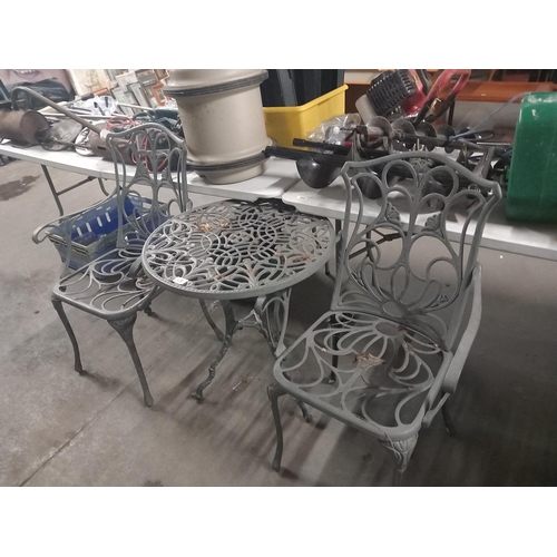 431 - Cast iron garden table with two chairs