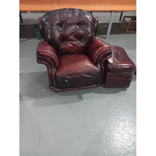 105 - A red leather chesterfield style armchair with footstool