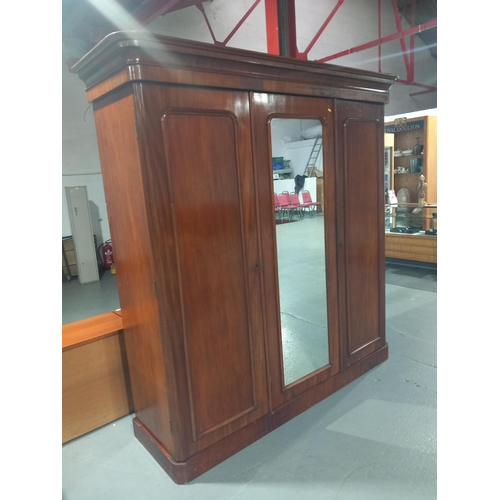 122 - A mahogany two sectioned single mirrored door wardrobe