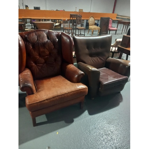 129 - A tan leather armchair together with a mid century style armchair